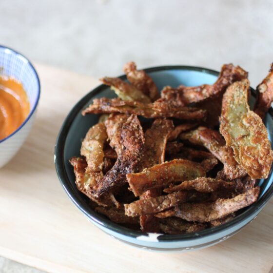 pot of crispy potato skins with chilli tahini dip