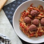 bowl of beetroot meatballs with pea pasta