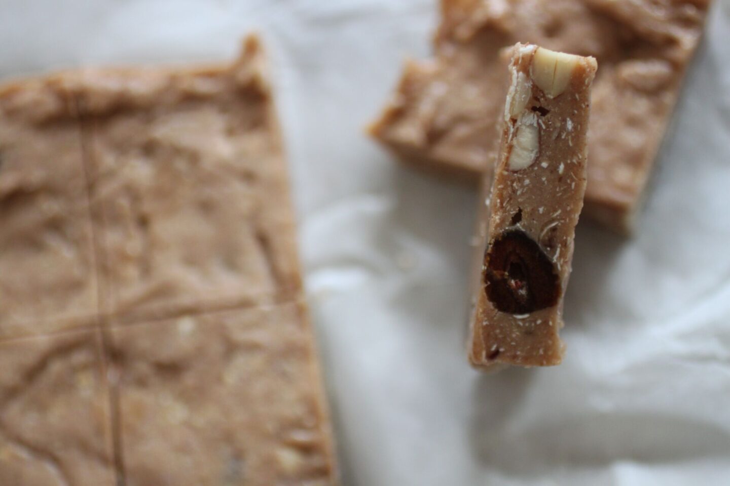 a close up of a cookie dough bar to show the texture of the add-ins
