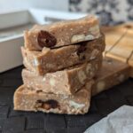 a stack of strawberry white chocolate cookie dough bars placed on a mat on a table