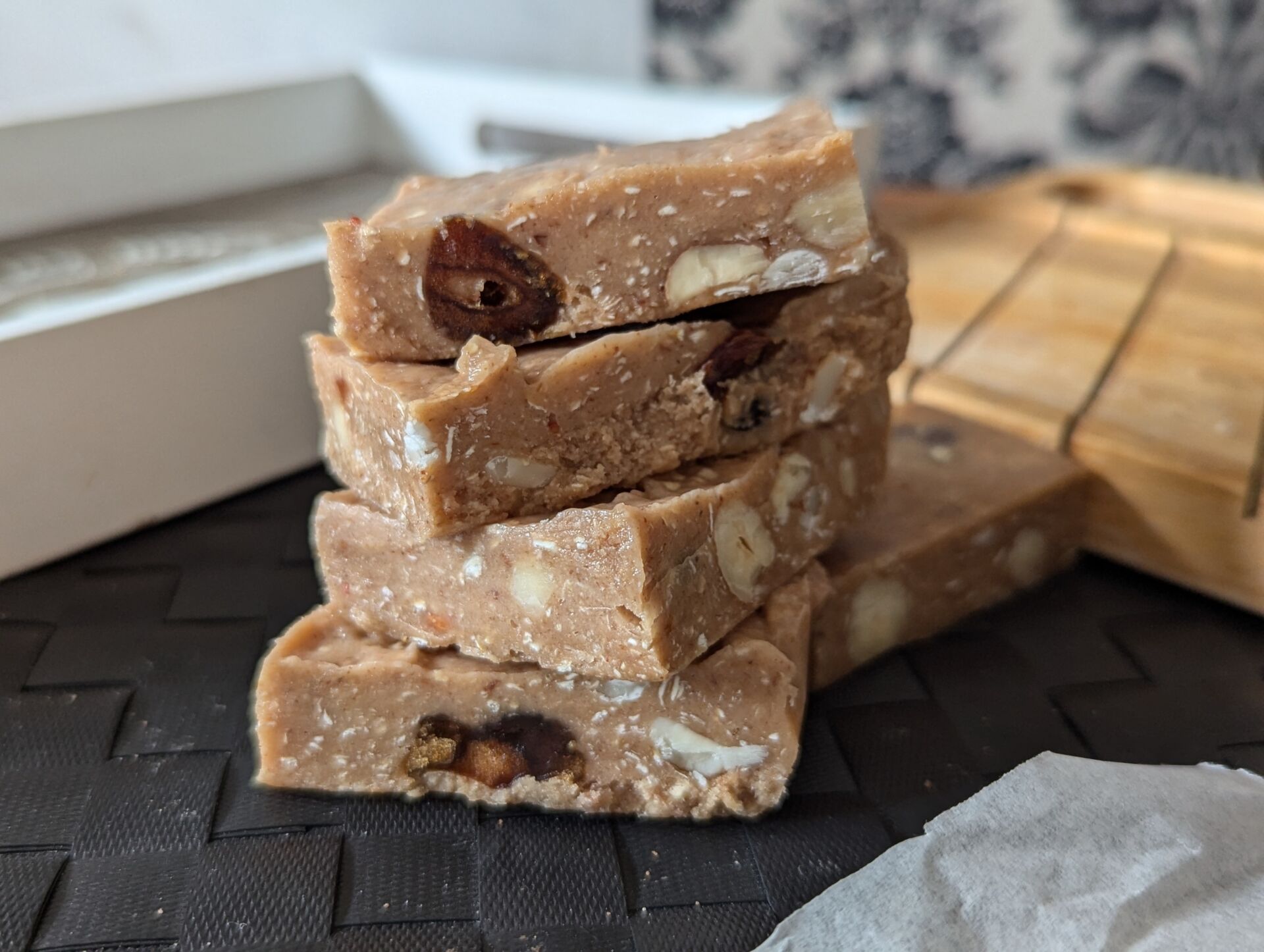 a stack of strawberry white chocolate cookie dough bars placed on a mat on a table