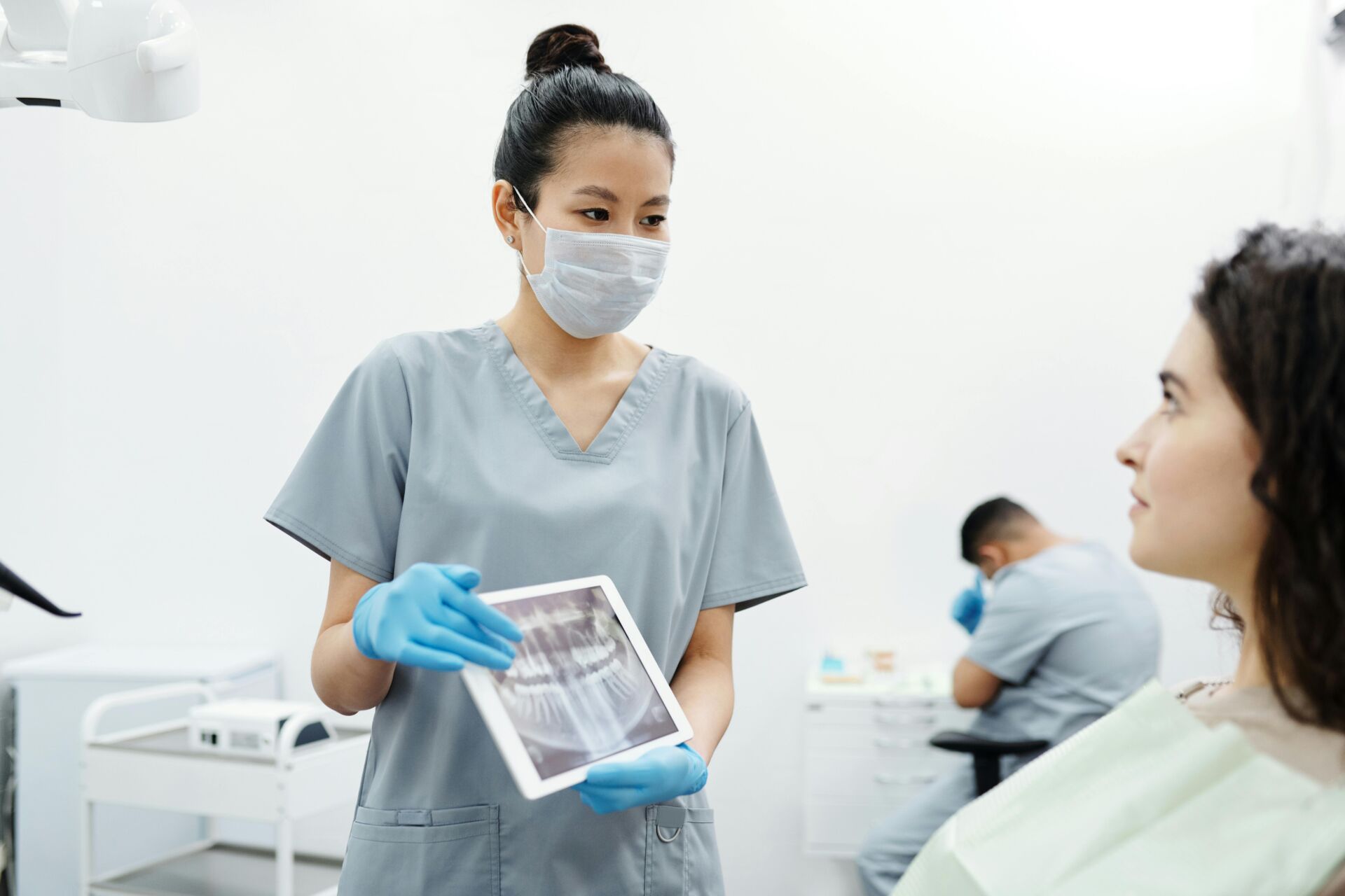 woman at the dentist being shown x-ray