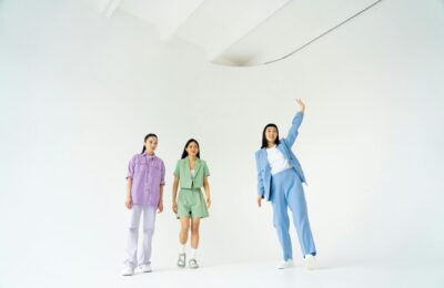 three women in different coloured co-ord outfits