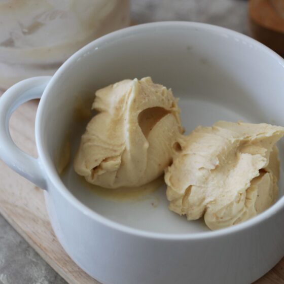 two scoops of vegan melon and peach ice cream in a white bowl