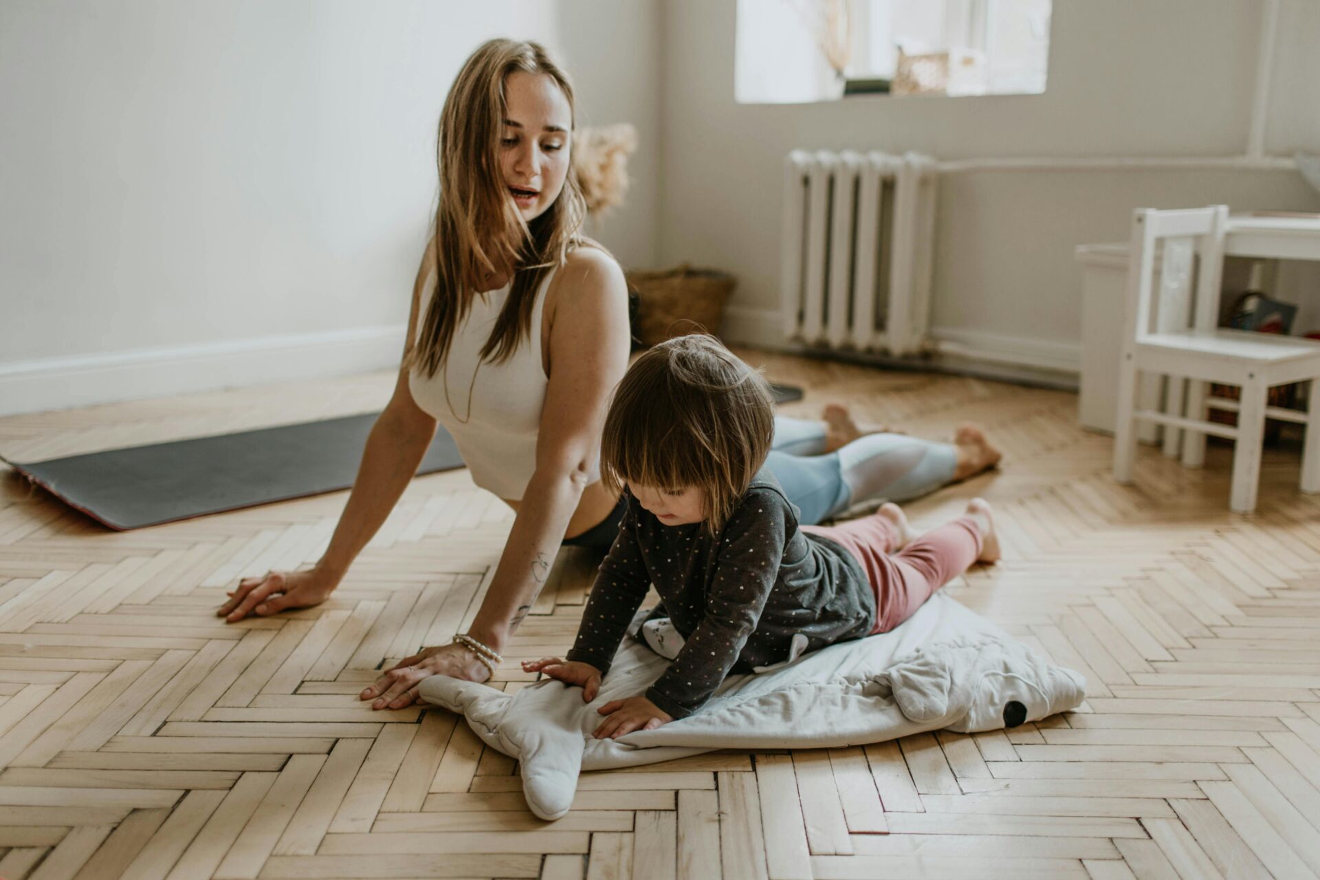 woman exercising on the floor with a child
