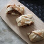 slices of apple braid on a wooden board, shot from above