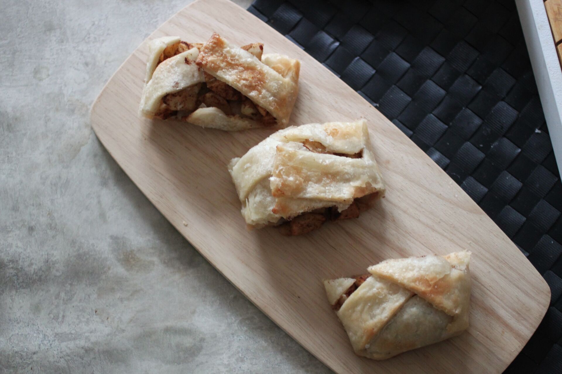slices of apple braid on a wooden board, shot from above