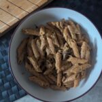 portrait photo of large pasta bowl filled with creamy courgette wild mushroom pasta