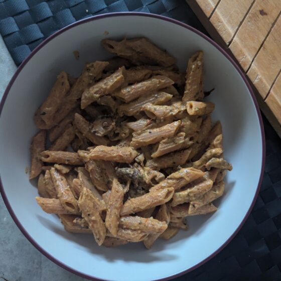 large pasta bowl filled with creamy courgette wild mushroom pasta