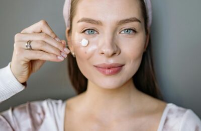 youthful woman applying skincare