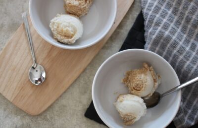 two bowls of orange & ginger ice cream on a table