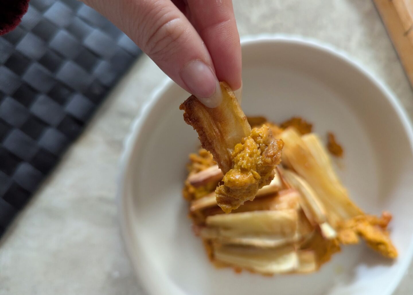 close up shot of a parsnip coated in the creamy carrot dip