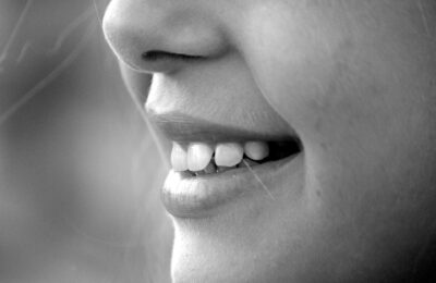 girl smiling, showing teeth