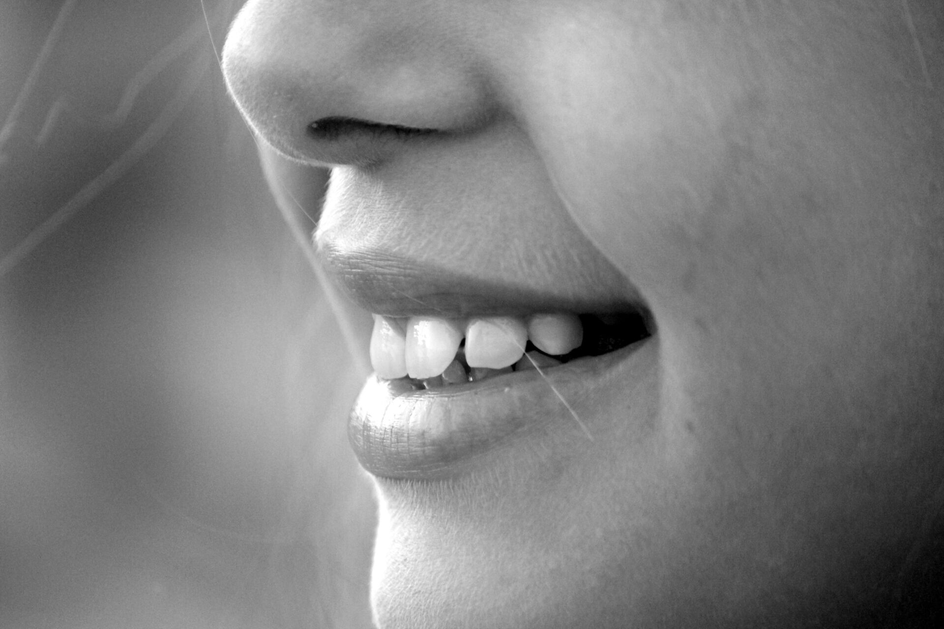 girl smiling, showing teeth