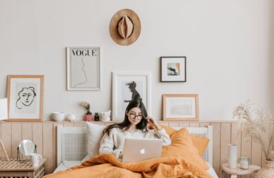 woman using laptop in bed