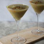 two frozen tropical mocktails in martini glasses