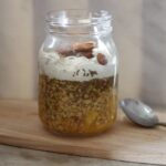 jar of tropical bircher muesli on a wooden tray