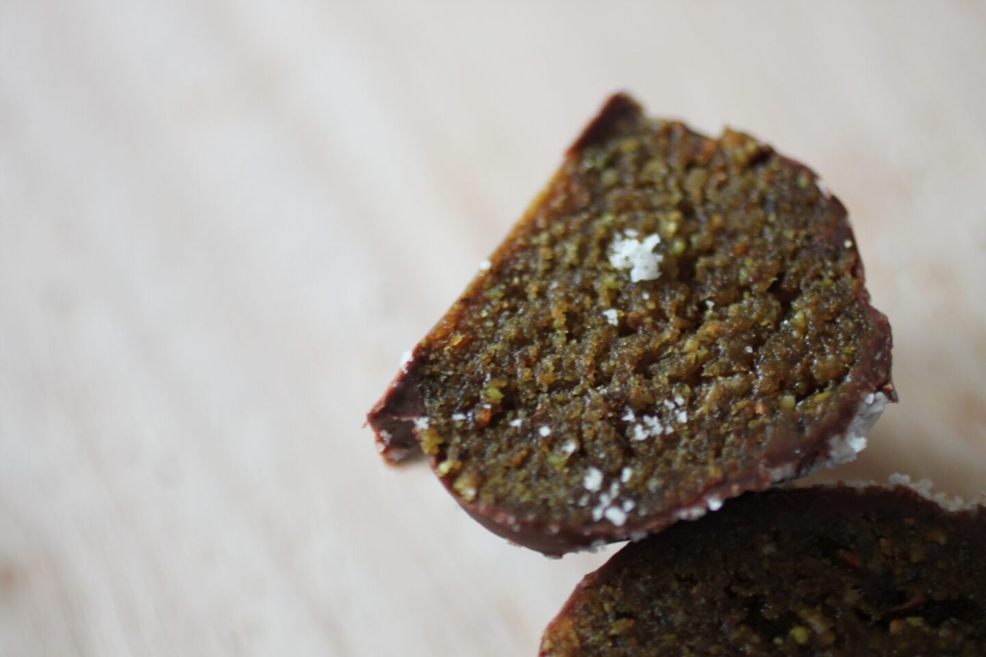 pistachio butter bite, chopped in half to show texture