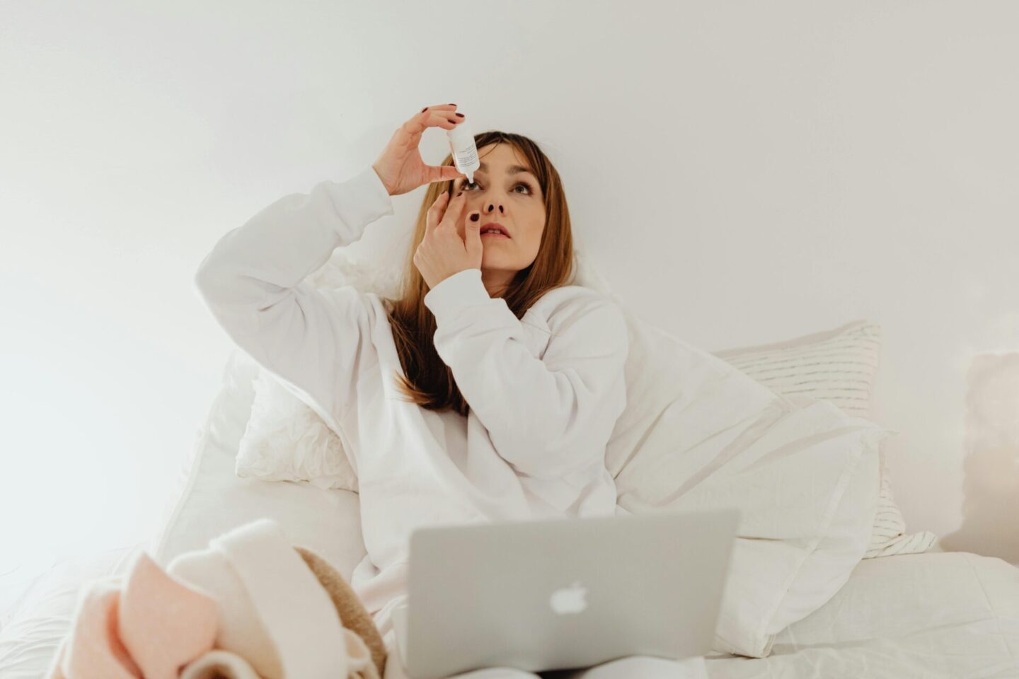 woman putting eye drops in