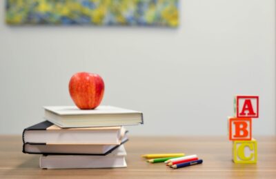 apple on some books on a desk