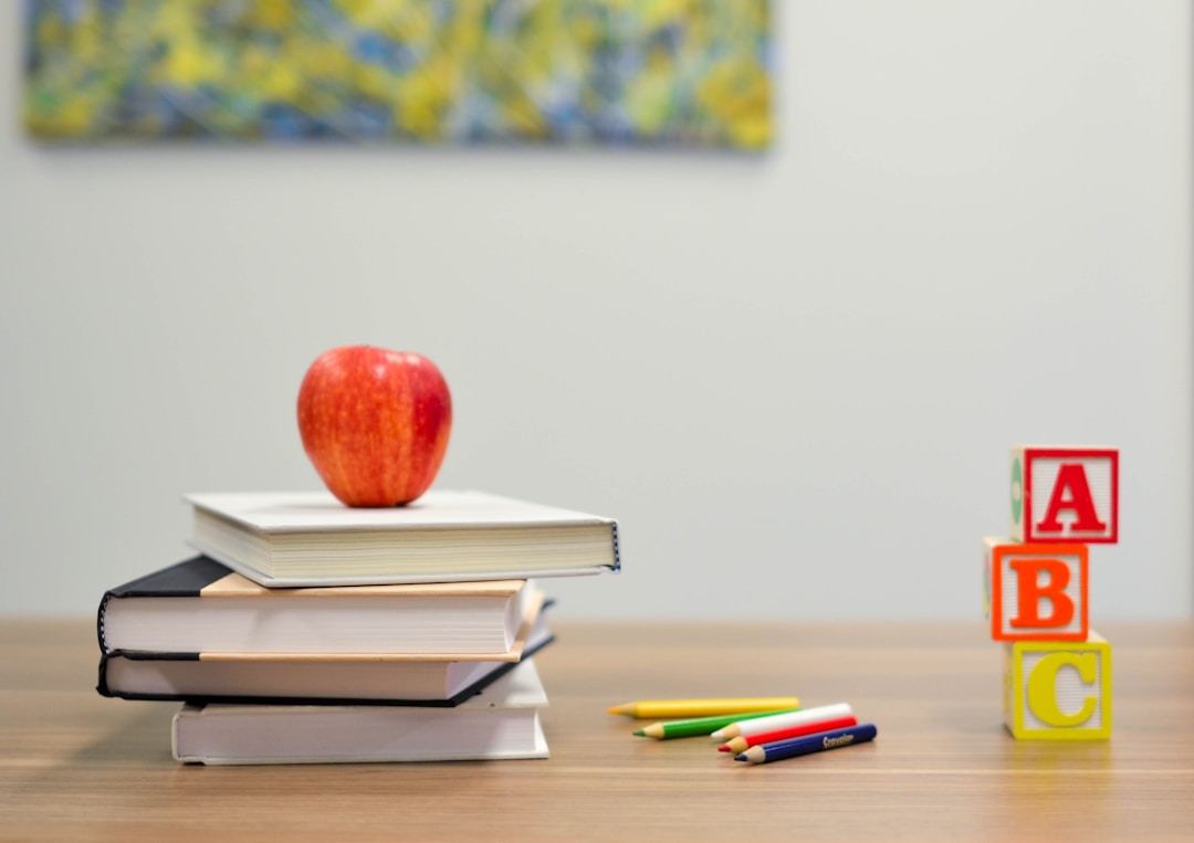 apple on some books on a desk