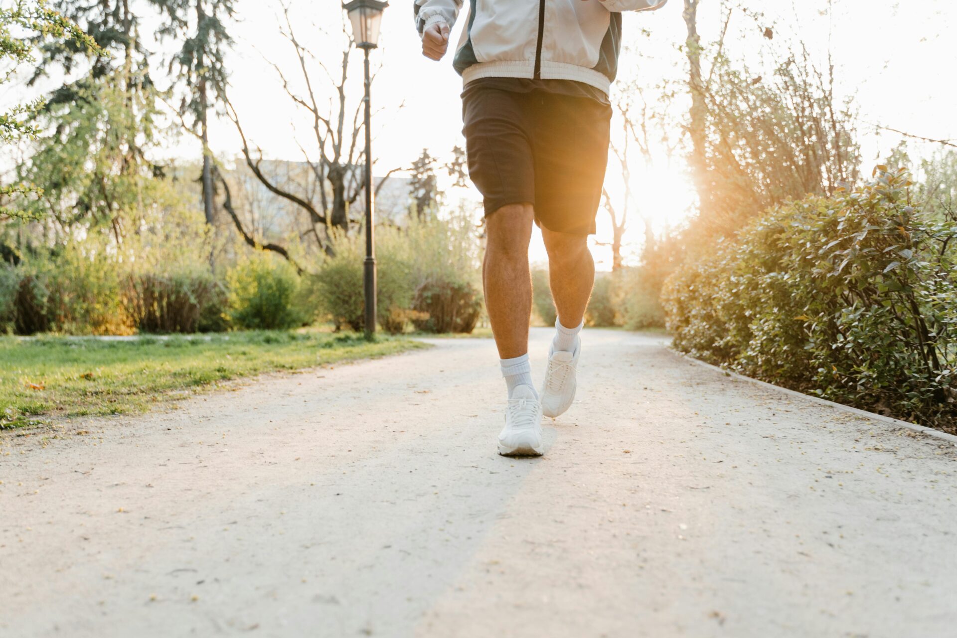 man running in classic white trainers