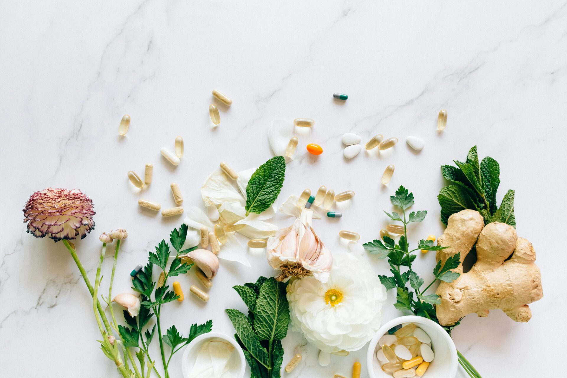 flat lay of flowers and supplements