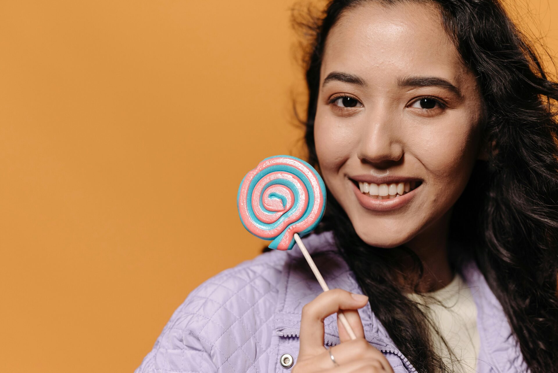 woman smiling holding a lolly