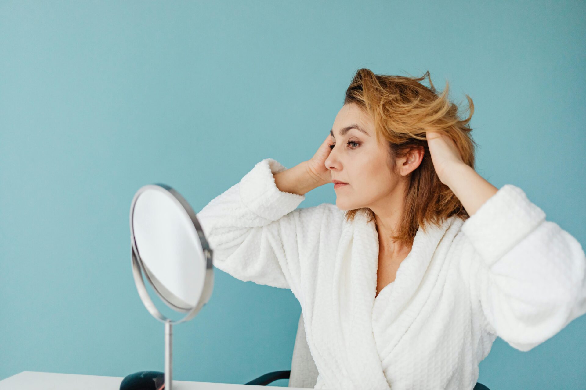 woman looking in mirror