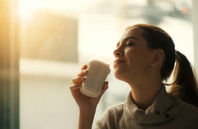 woman about to sip from coffee cup