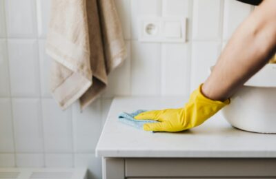 person cleaning bathroom