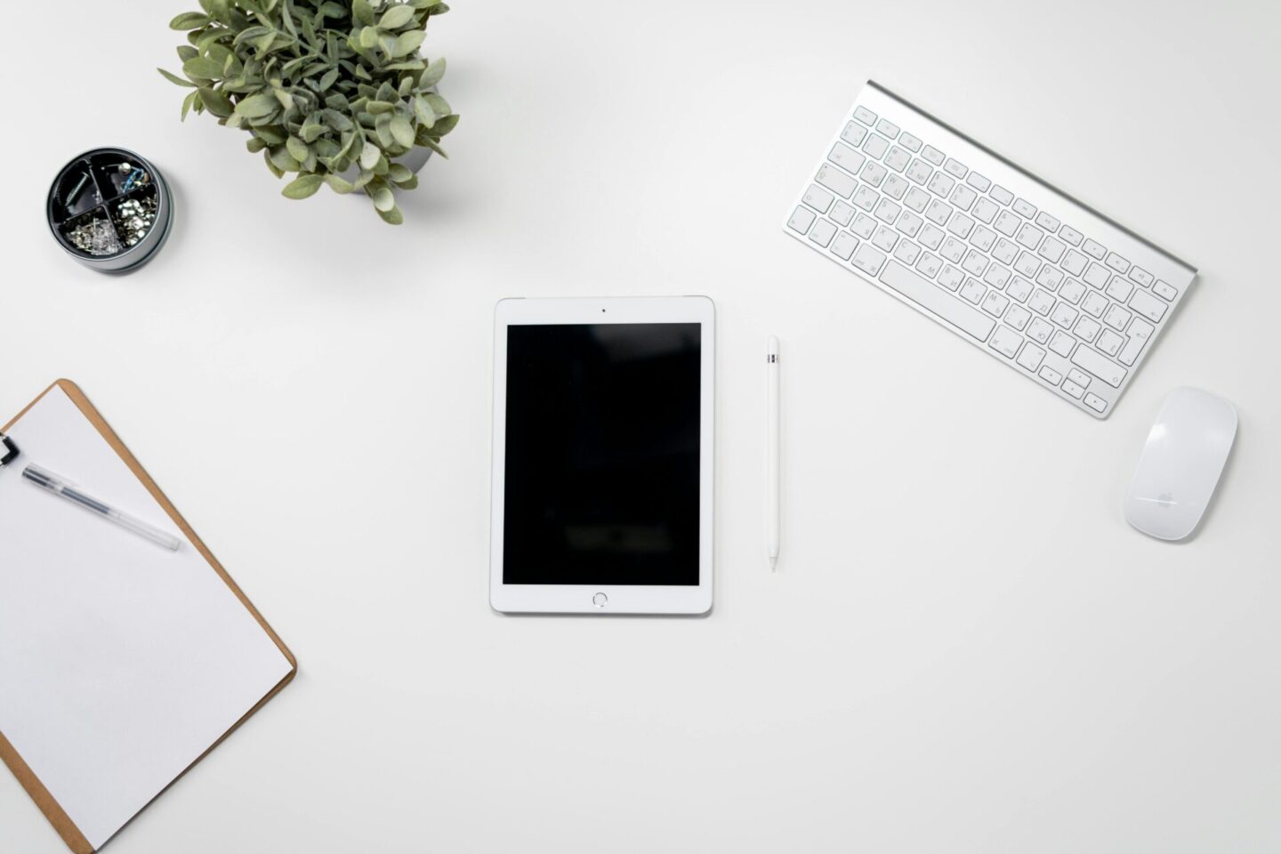 a tablet and keyboard on a table with a notebook