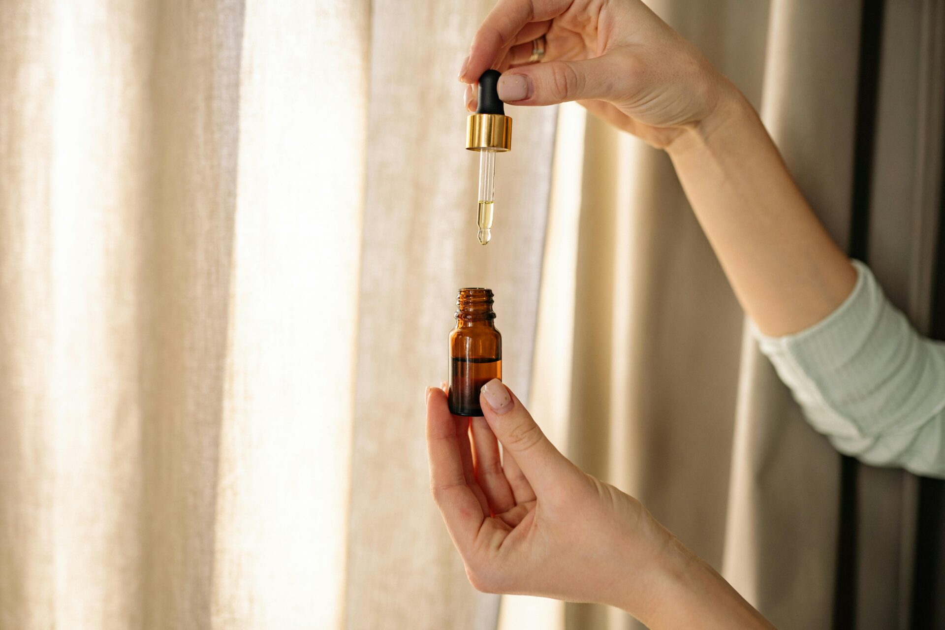 woman holding a bottle of facial oil