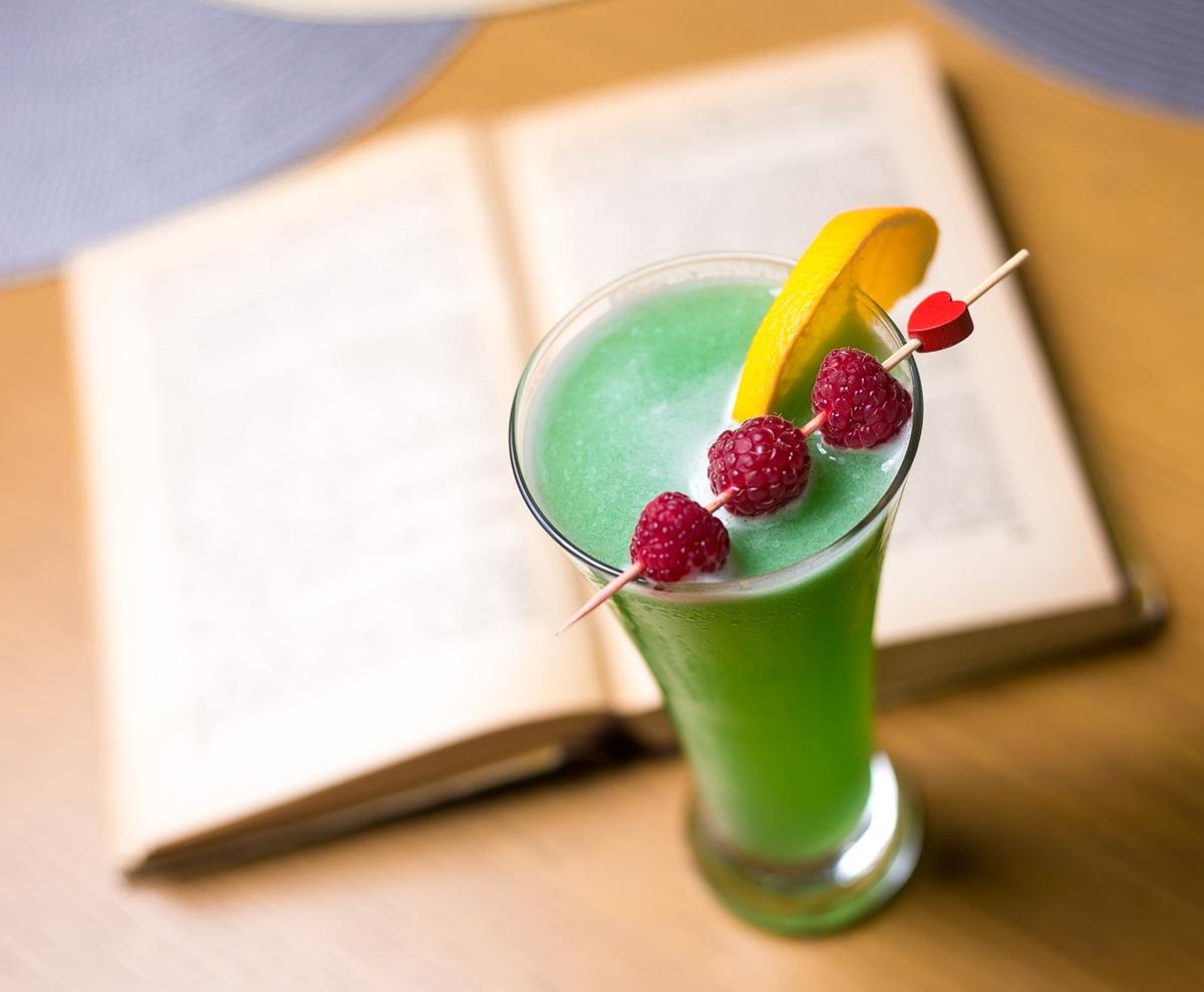 a green drink topped with berries