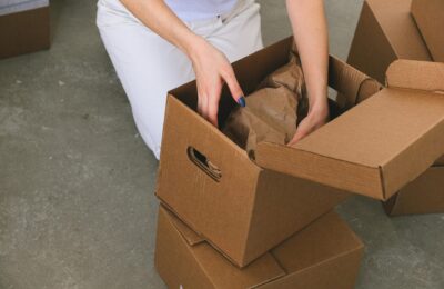 a woman packing moving boxes