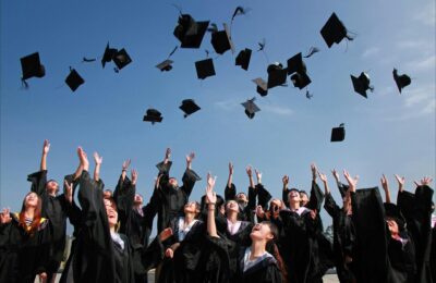 students throwing graduation caps in the air