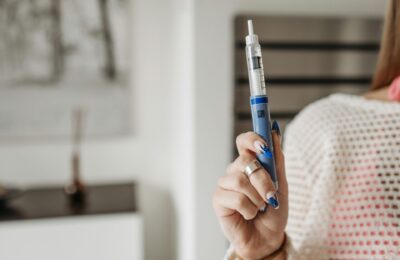 woman holding insulin injection