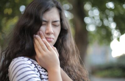 woman holding her jaw