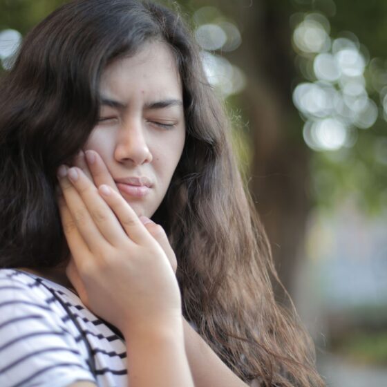 woman holding her jaw